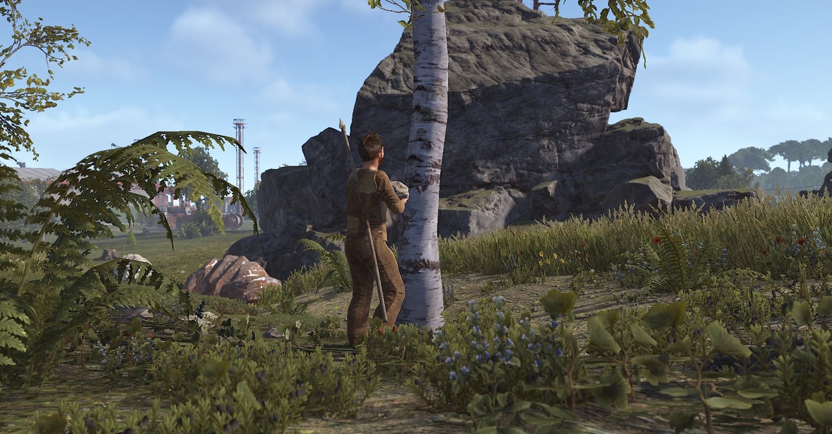 A Rust player chopping a tree